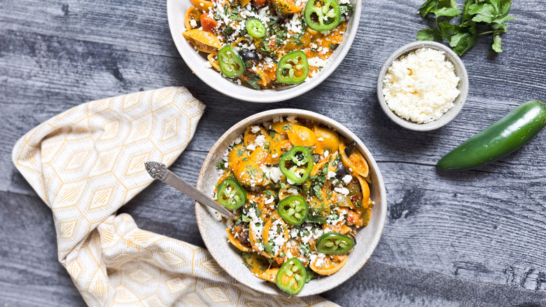 1-pot turkey taco pasta in serving bowls with garnishes on table