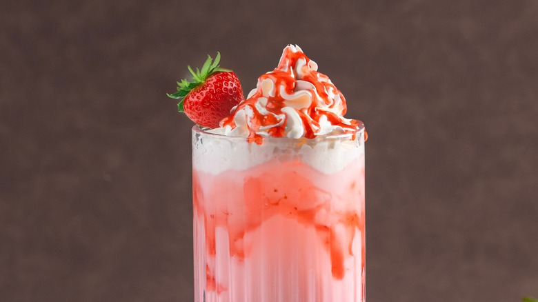 strawberry drink in glass with whipped cream