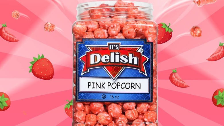 A bucet of pink popcorn by It's Delish with a pink background