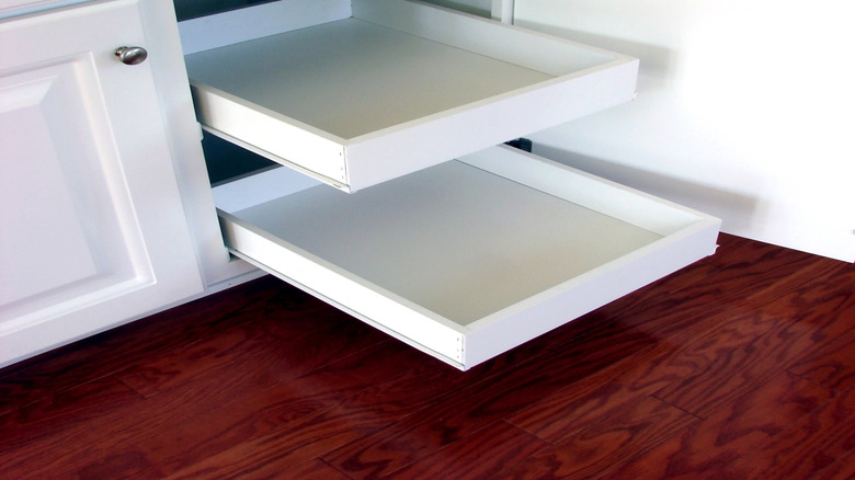 Pull-out drawers in a kitchen cabinet.