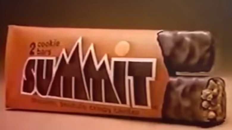 Image from Summit commercial showing orange package labeled Summit with right end open and two chocolate bars sticking out