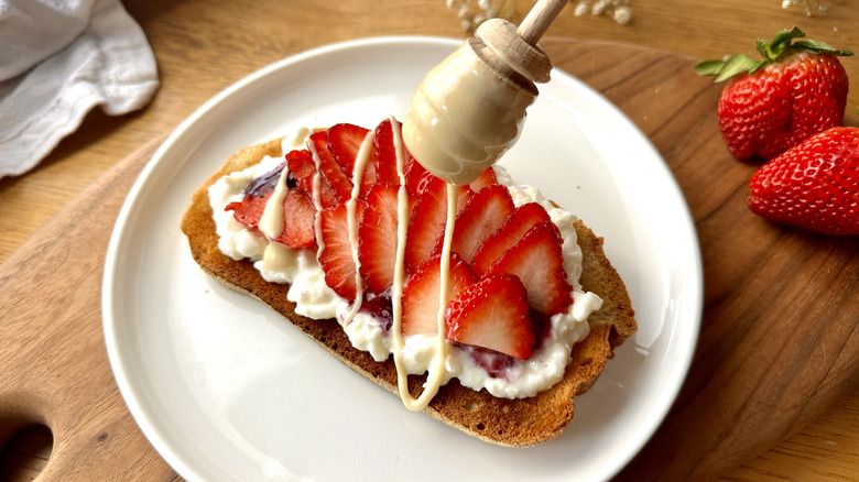 Whipped honey drizzled over strawberry toast