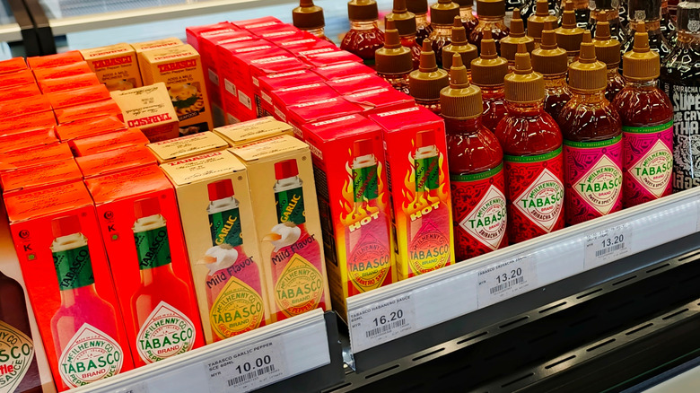 Bottles of Tabasco sauce on a grocery store shelf