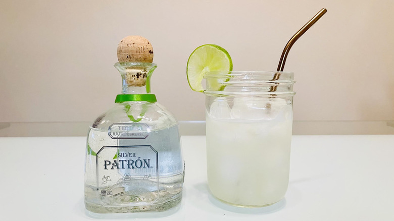 Bottle of Patrón tequila with a margarita