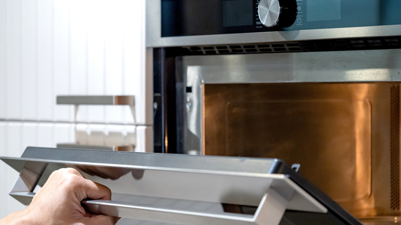 Person opening oven door