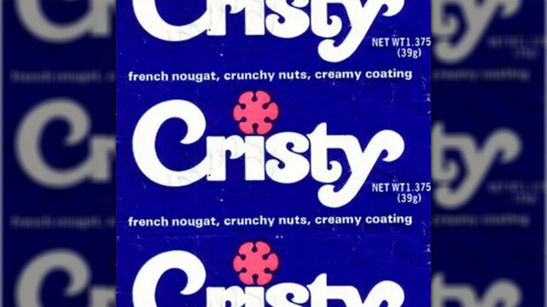 Wrapper for the Cristy candy bar showing white text on a blue background with a pink stylized flower as the dot in the "i."
