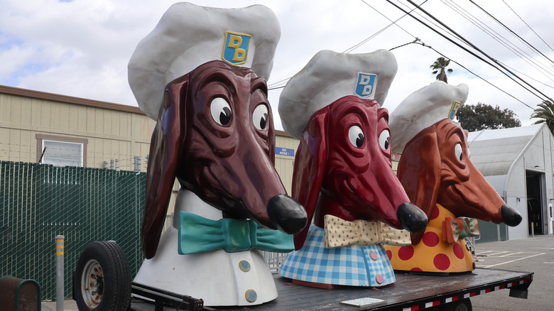 3 Doggie Diner dog mascots on a flatbed truck