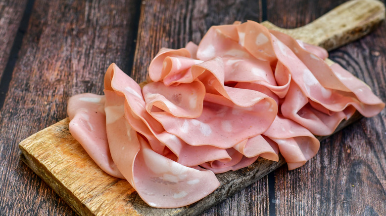 High quality bologna slices on a wooden cutting board