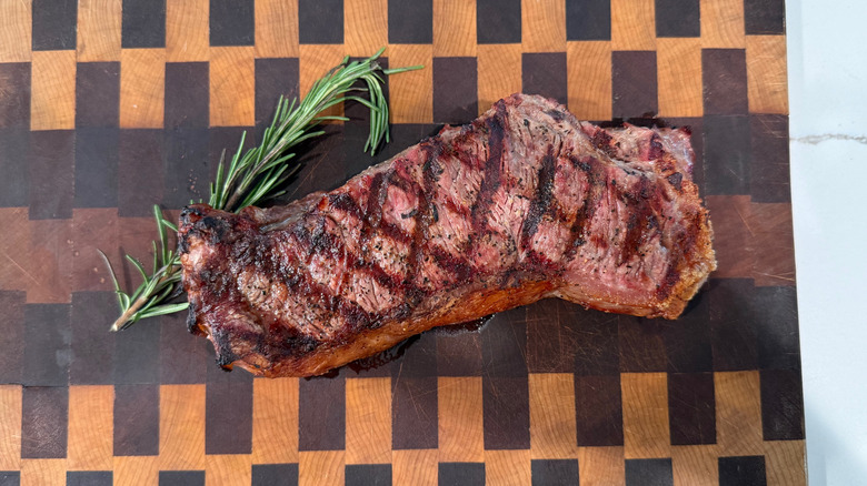 a grilled strip steak with a sprig of rosemary