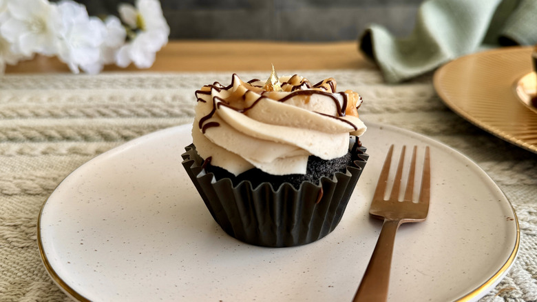 single chocolate stout cupcake with buttercream on plate