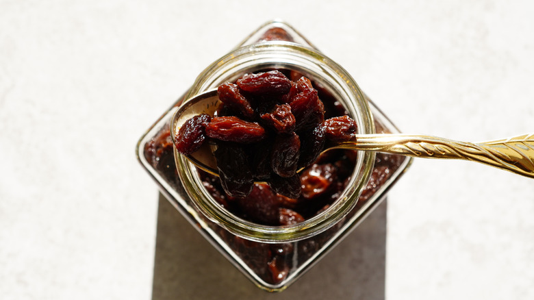 Raisins in a jar with a spoon