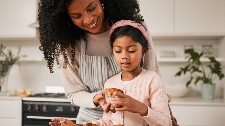 Woman and child baking muffins
