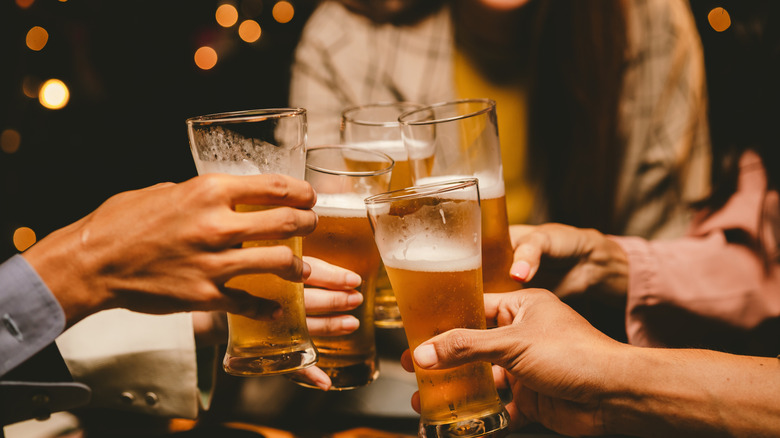 Friends raising glasses of beer