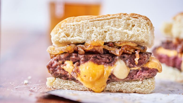 hamburger with cheese on table