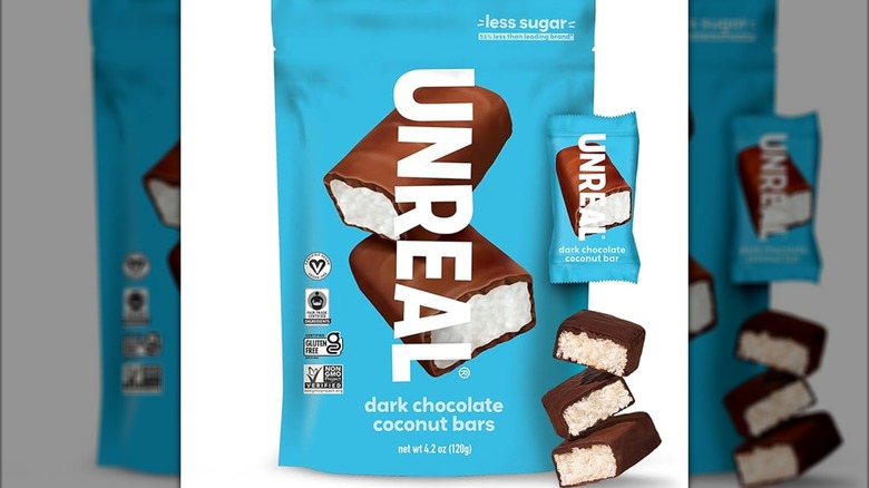 A bag of Unreal dark chocolate bars on a white background