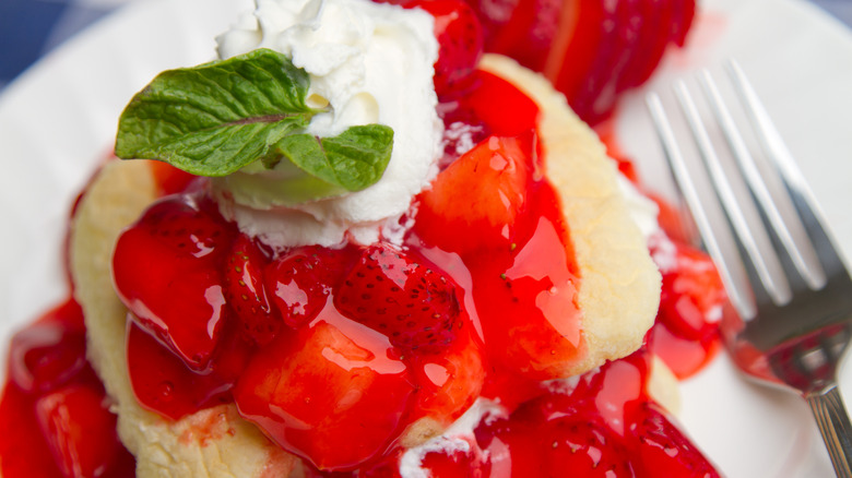 Strawberry shortcake with sauce and mint leaves