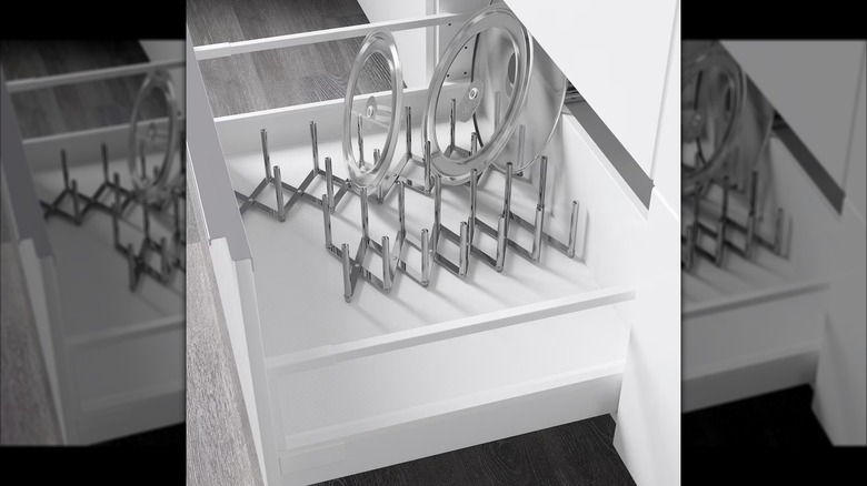 Metal pot lid organizer in kitchen drawer