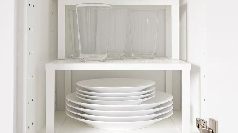 Cabinet organizer holding cups and plates