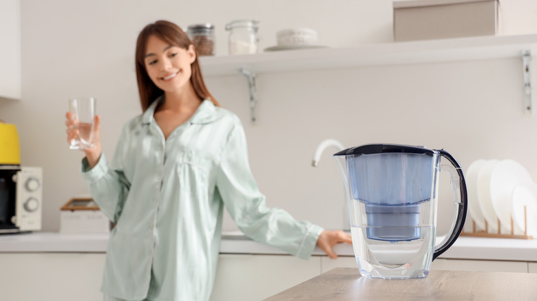 Woman smiling at water jug