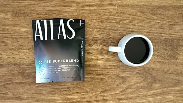 a bag of Atlas mushroom coffee next to a mug of it