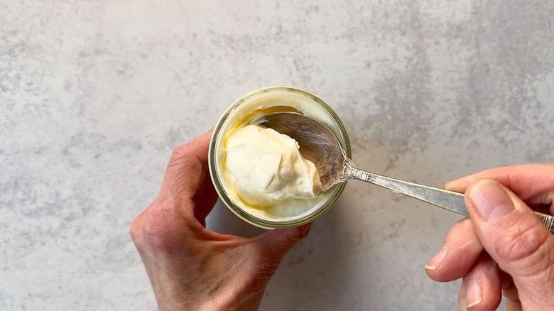 Homemade creme fraiche in jar with spoon