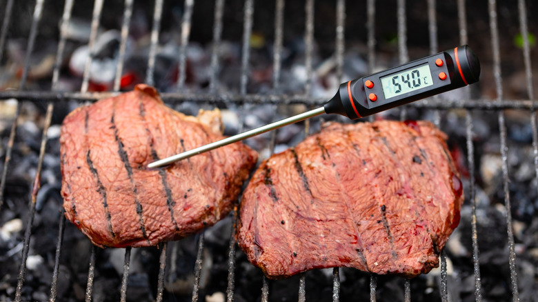 Using a probe thermometer to check the temperature of a steak