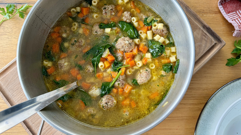 vegetable, meatball, and pasta soup in a metal pot