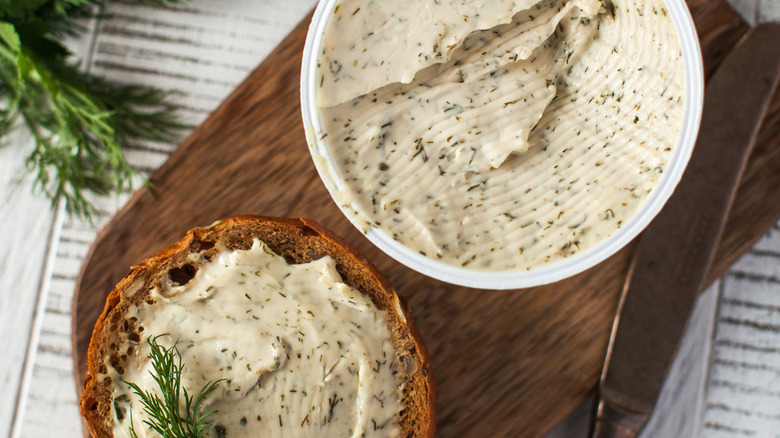 Compound butter bowl and bread on brown surface