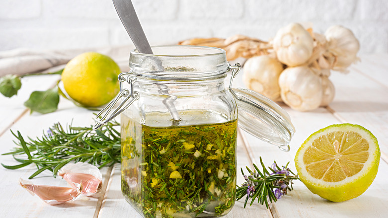 Salad dressing in a jar with lemons and garlic