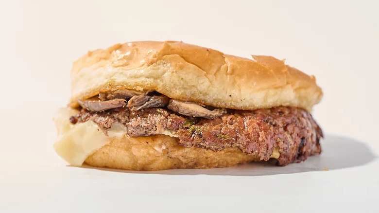 a Culver's mushroom and Swiss burger against a plain background