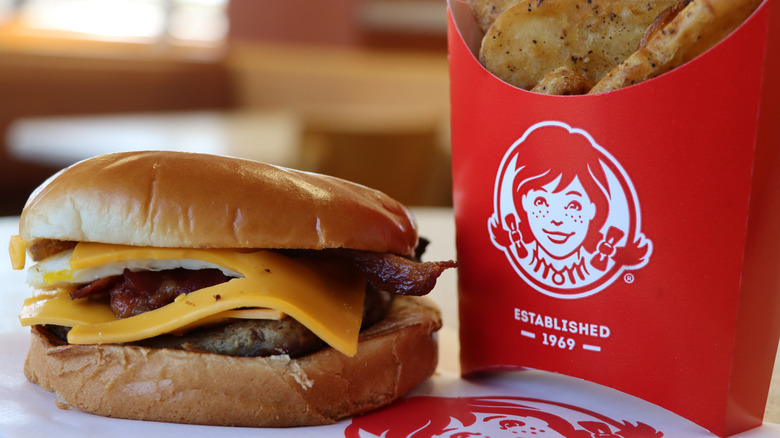 Wendy's breakfast Baconator sitting next to fries